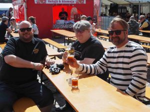 kolme miestä juo olutta